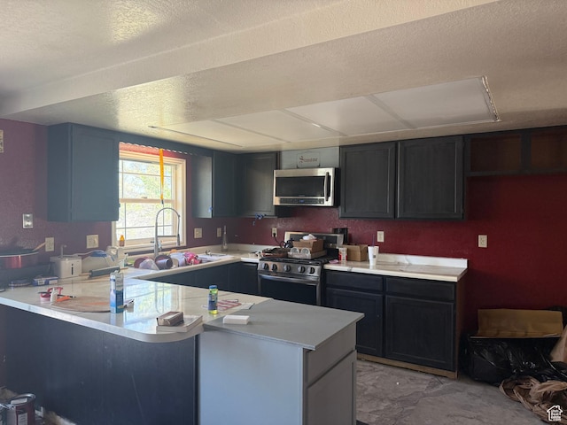 3438 W 500 S, Vernal, UT 84078 - kitchen with stainless steel appliances, a peninsula, light countertops, and a textured ceiling