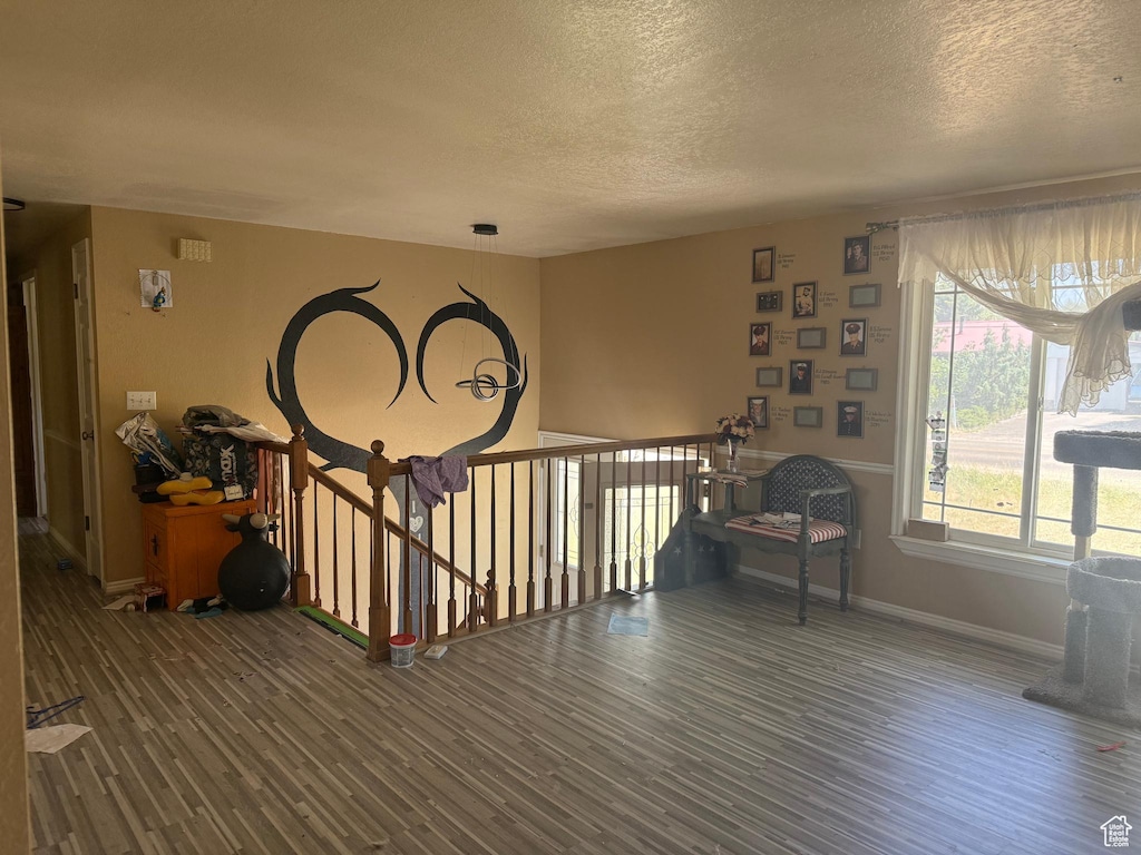 3438 W 500 S, Vernal, UT 84078 - sitting room featuring wood finished floors, a textured ceiling, and an upstairs landing