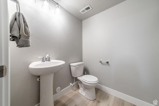 2259 S 1180 W Unit 12, Nibley, UT 84321 - half bathroom with wood finished floors and a textured ceiling