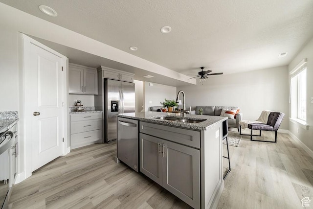 2259 S 1180 W Unit 12, Nibley, UT 84321 - kitchen with gray cabinets, appliances with stainless steel finishes, light wood-type flooring, a ceiling fan, and recessed lighting