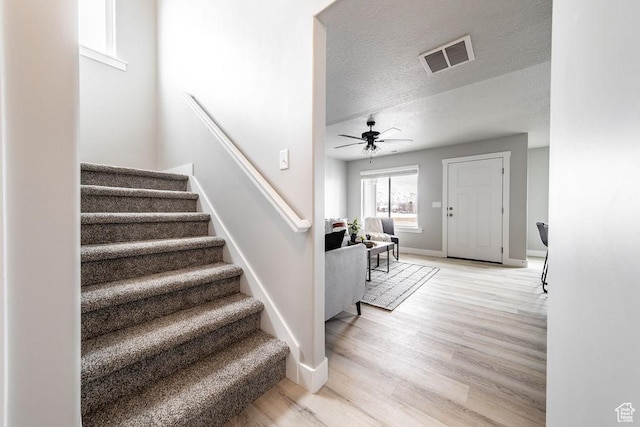 2259 S 1180 W Unit 12, Nibley, UT 84321 - stairway with wood finished floors, a ceiling fan, and a textured ceiling