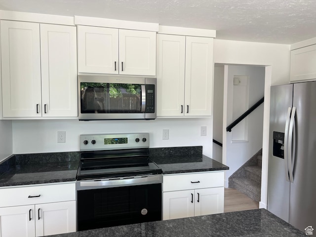 686 N Parkway Ave, Tooele, UT 84074 - kitchen featuring stainless steel appliances, white cabinets, and dark stone counters