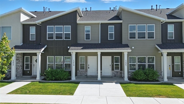 1221 W 1870 S, Logan, UT 84321 - view of property with board and batten siding, stone siding, a shingled roof, and a front yard