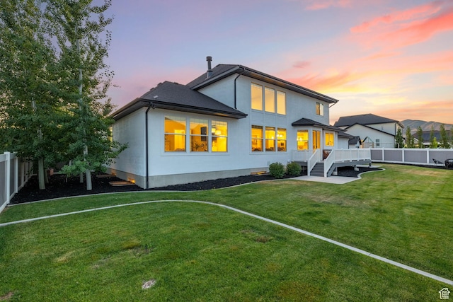 2430 N 325 E, Lehi, UT 84043 - rear view of property featuring a fenced backyard, stucco siding, and a wooden deck
