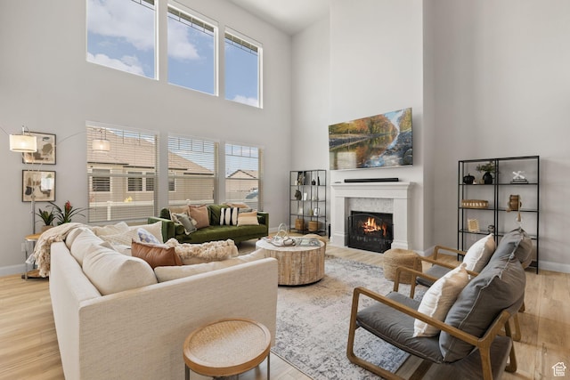 2430 N 325 E, Lehi, UT 84043 - living room with a towering ceiling, wood finished floors, and a lit fireplace