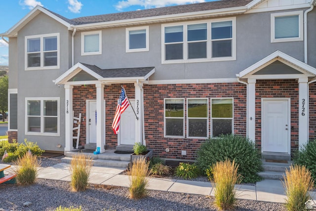 2722 E Iron Bark Aly, Eagle Mountain, UT 84005 - townhome / multi-family property featuring stucco siding, brick siding, and a shingled roof