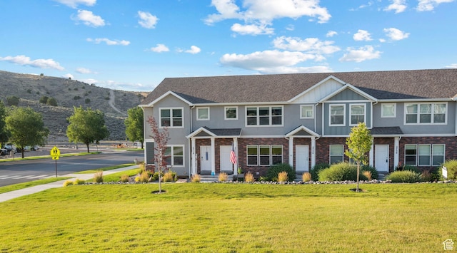 2722 E Iron Bark Aly, Eagle Mountain, UT 84005 - multi unit property featuring a front yard, brick siding, stucco siding, and a mountain view