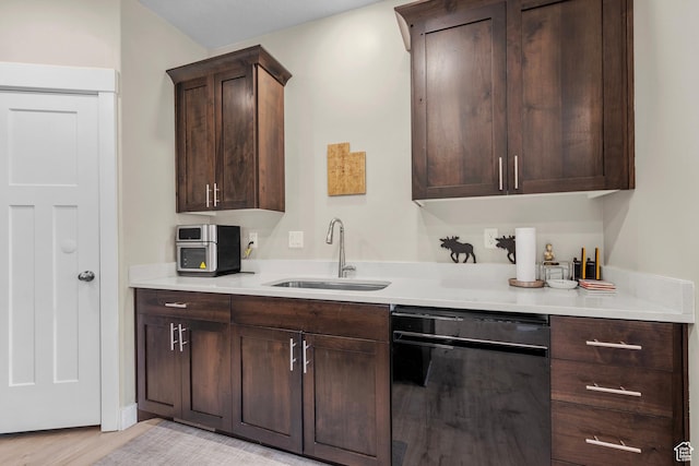 2722 E Iron Bark Aly, Eagle Mountain, UT 84005 - kitchen featuring dishwasher, dark brown cabinets, light countertops, and light wood finished floors