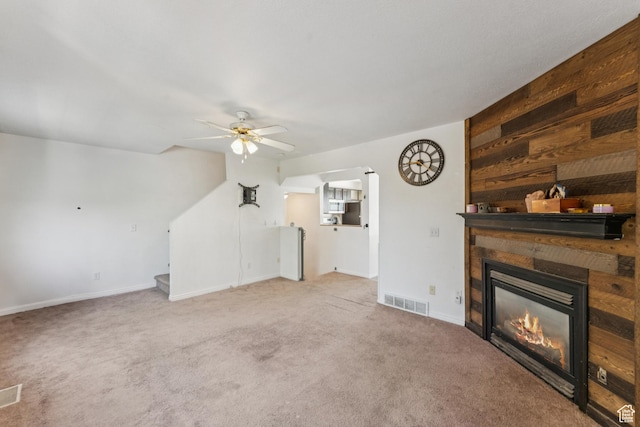 1791 W 5125 S, Roy, UT 84067 - unfurnished living room with a glass covered fireplace, carpet floors, ceiling fan, and stairway