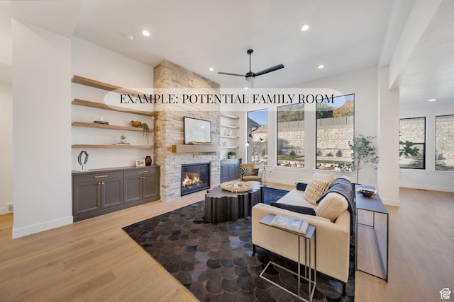 369 N Amber Ln W, Layton, UT 84041 - living room with light wood-type flooring, a ceiling fan, a stone fireplace, and recessed lighting
