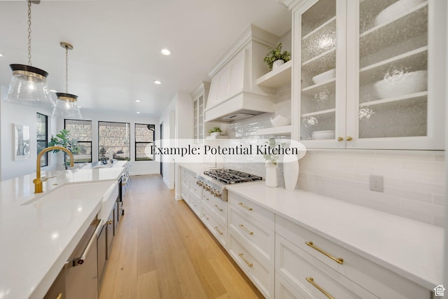 369 N Amber Ln W, Layton, UT 84041 - kitchen with stainless steel gas cooktop, light wood-type flooring, backsplash, white cabinets, and premium range hood