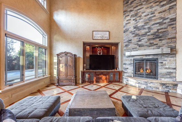 694 W Cephus Rd, Draper, UT 84020 - living room with inlaid floor details, a towering ceiling, and a fireplace