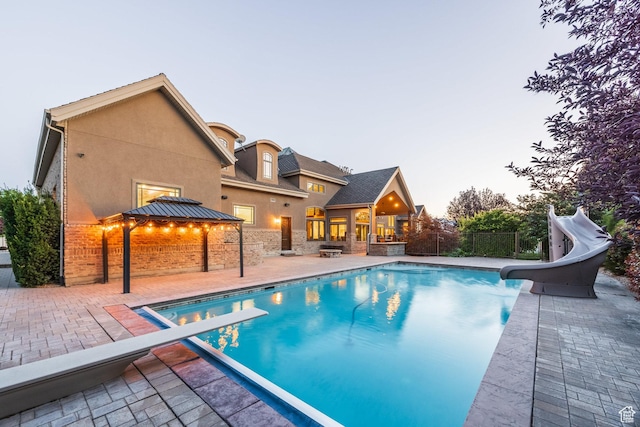 694 W Cephus Rd, Draper, UT 84020 - view of pool with a water slide, a gazebo, a patio area, and a diving board