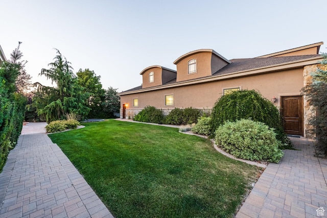 694 W Cephus Rd, Draper, UT 84020 - view of side of home with stucco siding, a yard, and stone siding