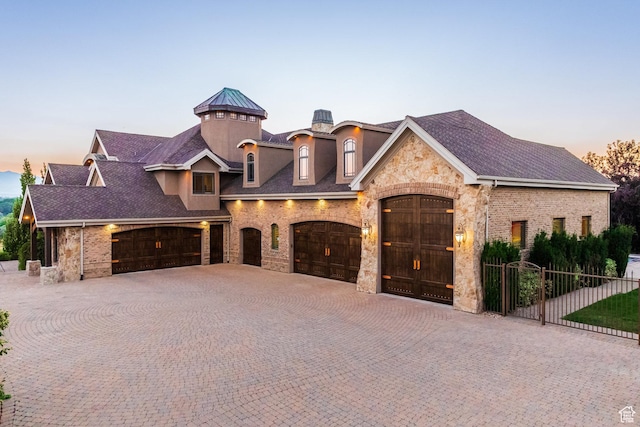 694 W Cephus Rd, Draper, UT 84020 - view of front of property with stone siding, a garage, and curved driveway
