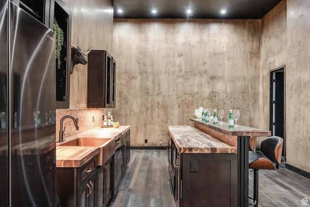 2836 S 2300th Cir E, St George, UT 84790 - bar featuring freestanding refrigerator, dark wood-style floors, and tasteful backsplash
