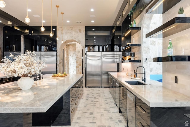 2836 S 2300th Cir E, St George, UT 84790 - kitchen with open shelves, dark cabinets, pendant lighting, light stone countertops, and decorative backsplash