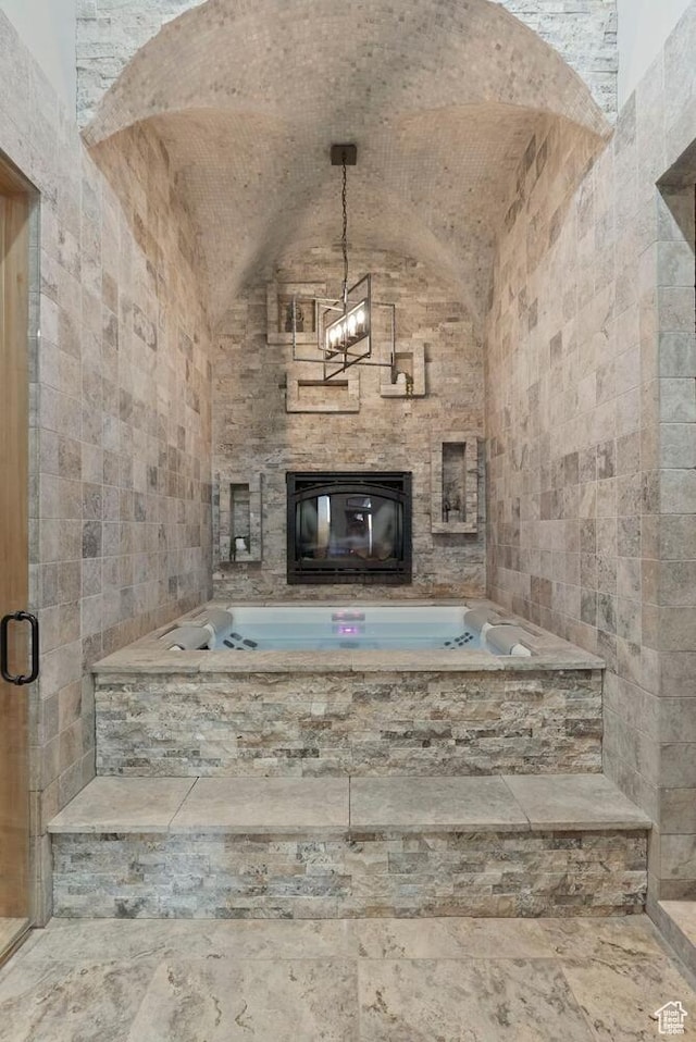2836 S 2300th Cir E, St George, UT 84790 - unfurnished living room with a glass covered fireplace, vaulted ceiling, and tile walls