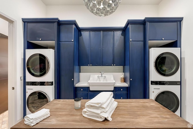 2836 S 2300th Cir E, St George, UT 84790 - laundry area featuring stacked washing machine and dryer, cabinet space, and a chandelier