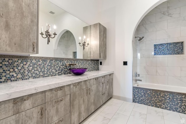2836 S 2300th Cir E, St George, UT 84790 - bathroom with tiled shower / bath combo, vanity, backsplash, and marble finish floors