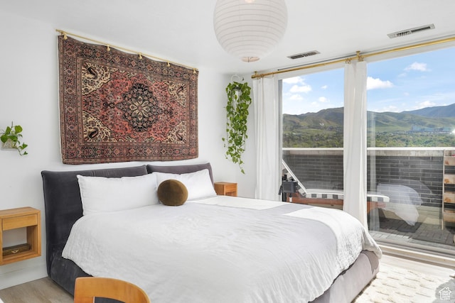 777 E S Temple S Unit 15E, Salt Lake City, UT 84102 - bedroom with wood finished floors and a mountain view