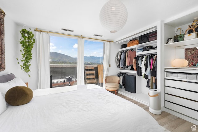 777 E S Temple S Unit 15E, Salt Lake City, UT 84102 - bedroom with wood finished floors, a mountain view, and a closet