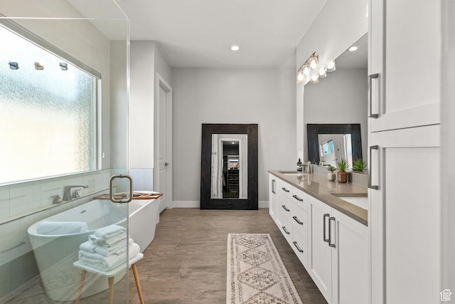 499 W Palo Verde Way Unit 61, Ivins, UT 84738 - bathroom featuring double vanity, wood finished floors, a soaking tub, and recessed lighting
