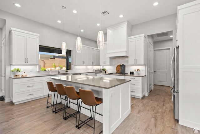 499 W Palo Verde Way Unit 61, Ivins, UT 84738 - kitchen with stainless steel appliances, a kitchen island, decorative backsplash, white cabinets, and recessed lighting