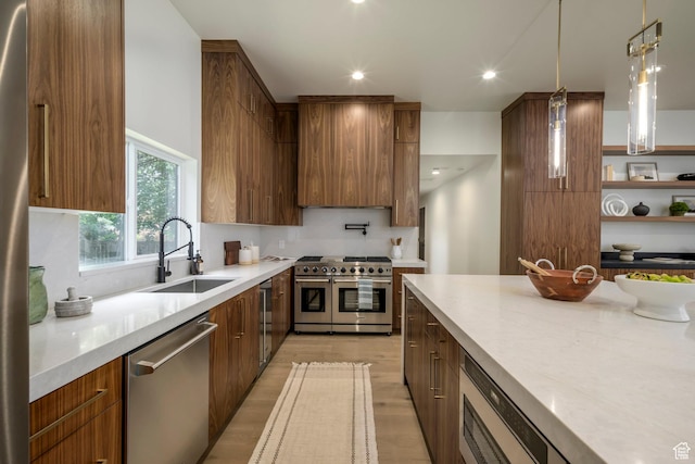 1958 E Longview Dr, Holladay, UT 84124 - kitchen with appliances with stainless steel finishes, modern cabinets, light wood-style floors, hanging light fixtures, and recessed lighting