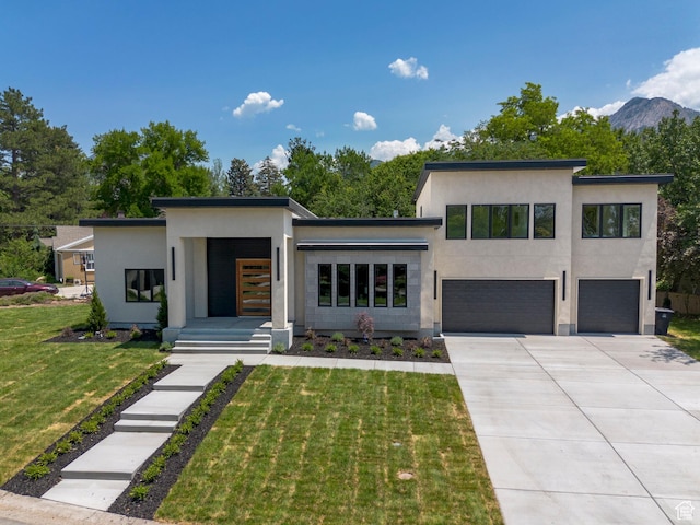 1958 E Longview Dr, Holladay, UT 84124 - modern home with an attached garage, stucco siding, concrete driveway, a front lawn, and a mountain view