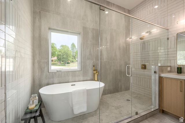 1958 E Longview Dr, Holladay, UT 84124 - bathroom with a soaking tub, vanity, a stall shower, and tile walls