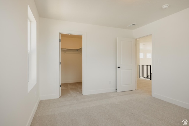 1026 W Chokecherry Dr Unit 135, Mapleton, UT 84664 - unfurnished bedroom featuring light colored carpet and a walk in closet