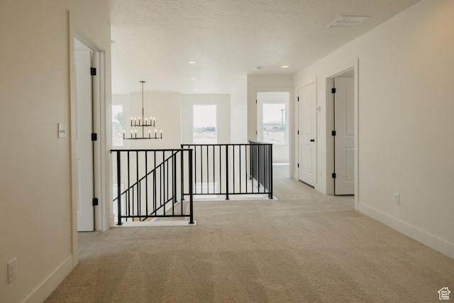 1026 W Chokecherry Dr Unit 135, Mapleton, UT 84664 - hall with an upstairs landing, carpet floors, a chandelier, and recessed lighting
