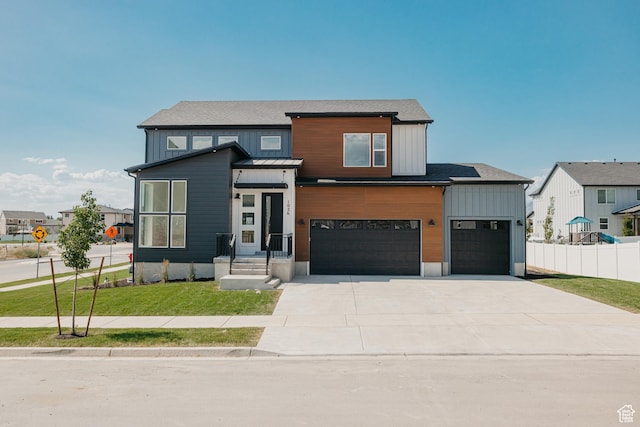 1026 W Chokecherry Dr Unit 135, Mapleton, UT 84664 - view of front of property featuring an attached garage, driveway, and board and batten siding