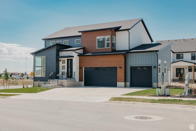 1026 W Chokecherry Dr Unit 135, Mapleton, UT 84664 - view of front of house featuring driveway, an attached garage, board and batten siding, and a shingled roof