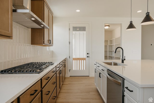 1026 W Chokecherry Dr Unit 135, Mapleton, UT 84664 - kitchen featuring wall chimney exhaust hood, appliances with stainless steel finishes, light wood-style floors, recessed lighting, and hanging light fixtures