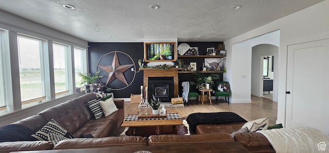 1275 S Lawrence Rd, Huntington, UT 84528 - living area with arched walkways, wood finished floors, and a textured ceiling