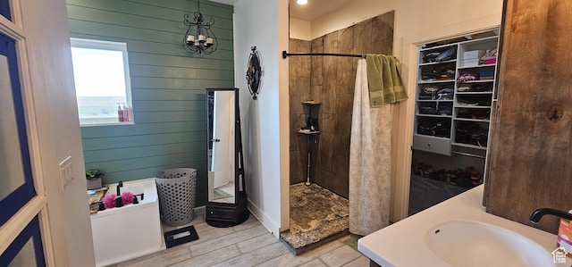 1275 S Lawrence Rd, Huntington, UT 84528 - bathroom with a stall shower, wood walls, a chandelier, and wood finished floors