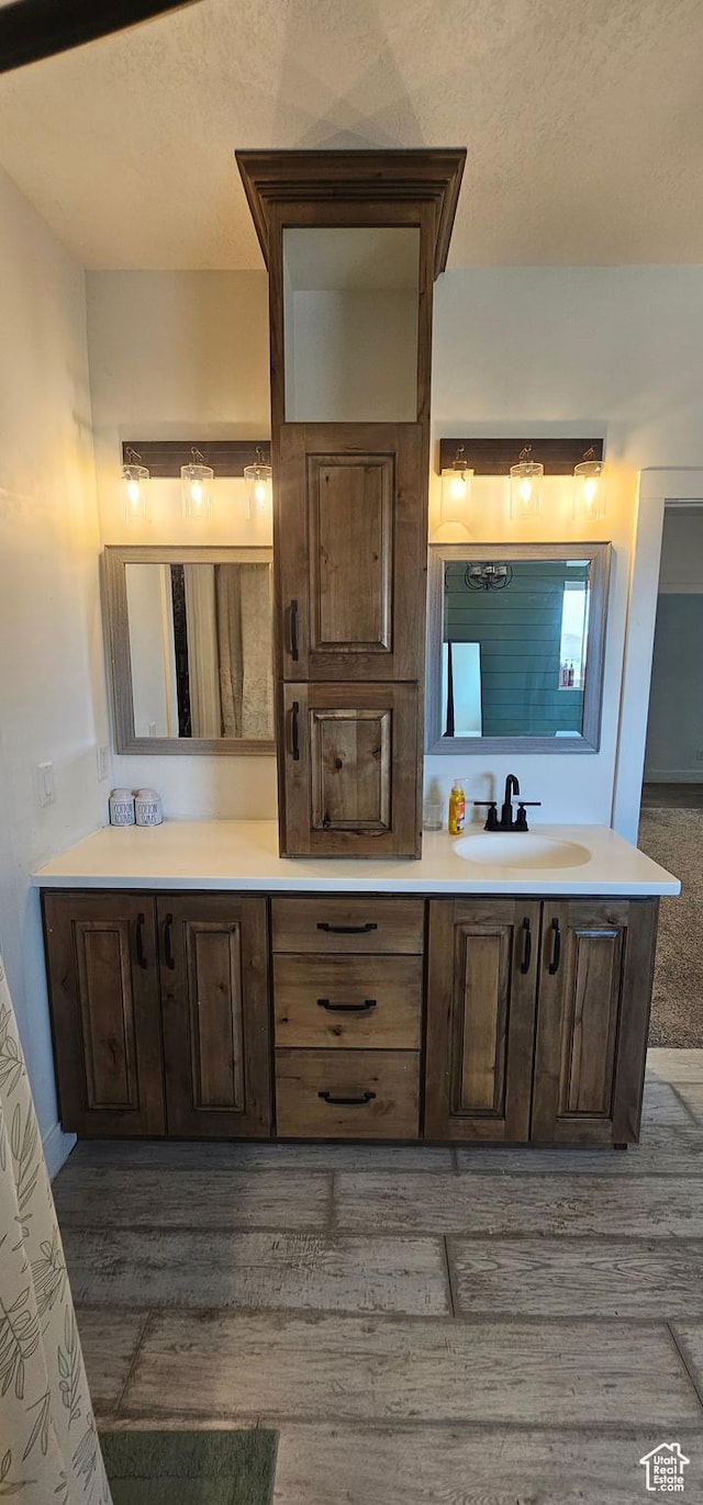 1275 S Lawrence Rd, Huntington, UT 84528 - full bathroom with double vanity and wood finished floors