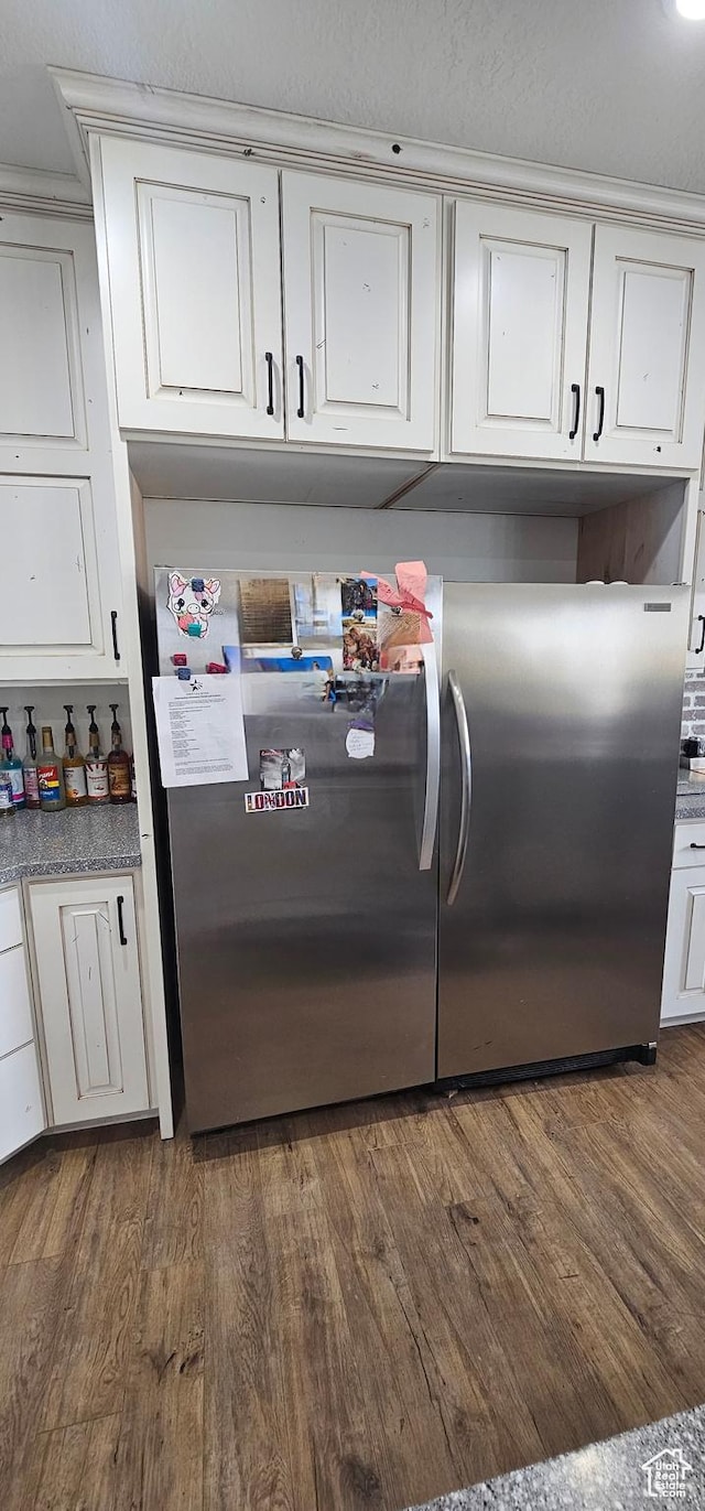 1275 S Lawrence Rd, Huntington, UT 84528 - kitchen with freestanding refrigerator, dark wood-style flooring, and white cabinets