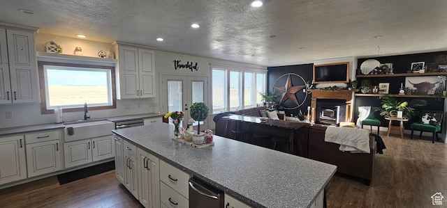 1275 S Lawrence Rd, Huntington, UT 84528 - kitchen with a fireplace, a textured ceiling, dark wood-type flooring, recessed lighting, and french doors