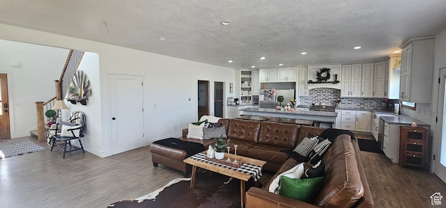 1275 S Lawrence Rd, Huntington, UT 84528 - living room featuring recessed lighting, wood finished floors, a textured ceiling, and stairs