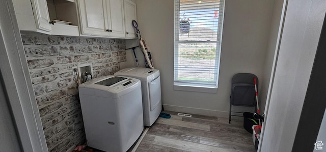 1275 S Lawrence Rd, Huntington, UT 84528 - washroom featuring washing machine and clothes dryer, cabinet space, and light wood-style floors