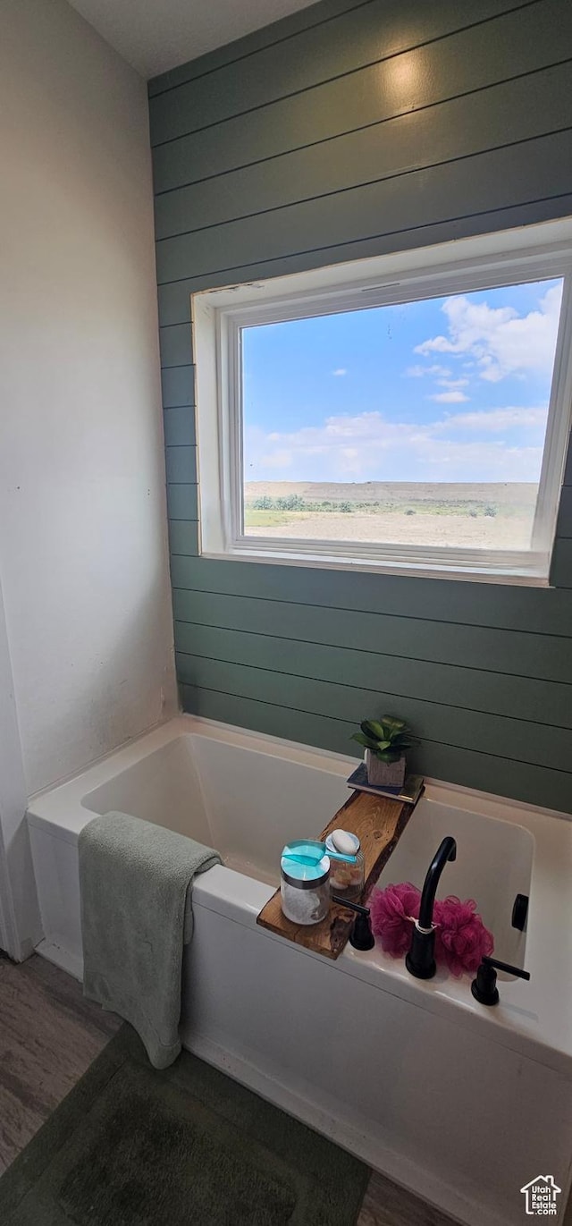 1275 S Lawrence Rd, Huntington, UT 84528 - bathroom featuring a garden tub, wood finished floors, and wood walls