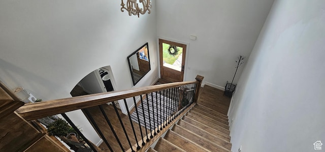1275 S Lawrence Rd, Huntington, UT 84528 - stairs with a high ceiling, wood finished floors, and a chandelier