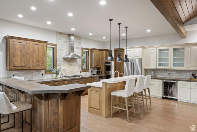 4014 W Hidden Cv Unit 11, Park City, UT 84098 - kitchen with wine cooler, appliances with stainless steel finishes, wall chimney exhaust hood, backsplash, and a kitchen breakfast bar