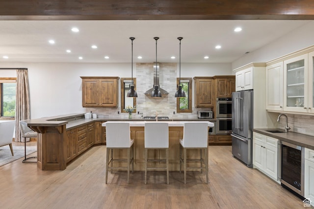 4014 W Hidden Cv Unit 11, Park City, UT 84098 - kitchen with beverage cooler, wall chimney range hood, stainless steel appliances, a kitchen bar, and recessed lighting