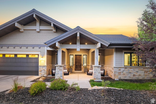 4014 W Hidden Cv Unit 11, Park City, UT 84098 - craftsman-style house with stone siding, covered porch, concrete driveway, and an attached garage