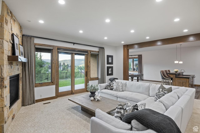 4014 W Hidden Cv Unit 11, Park City, UT 84098 - living room featuring recessed lighting, a stone fireplace, healthy amount of natural light, and light carpet
