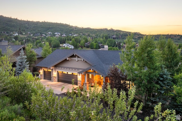 4014 W Hidden Cv Unit 11, Park City, UT 84098 - craftsman house with stone siding, a garage, concrete driveway, and roof with shingles